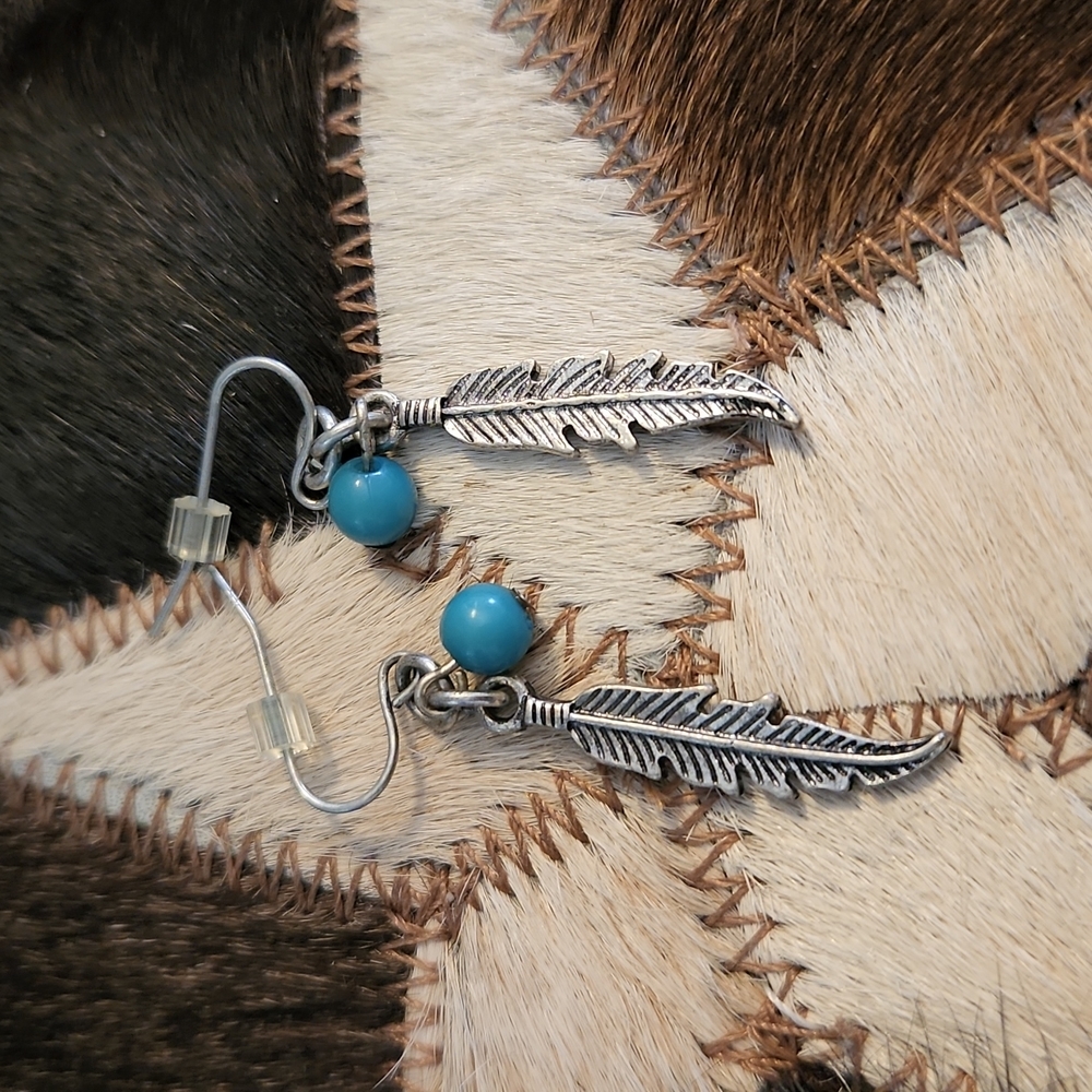 Silvertone feather and faux turquoise dangle earring
